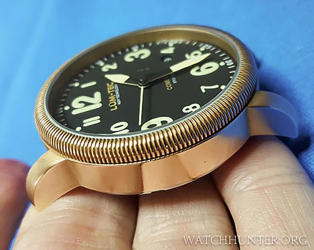 I purchased the watch devoid of patina. The bronze is more golden and brassy looking.