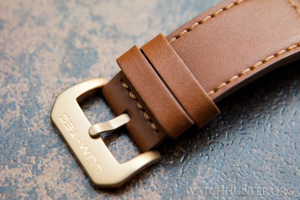 The leather watch band with bronzish buckle is excellent.