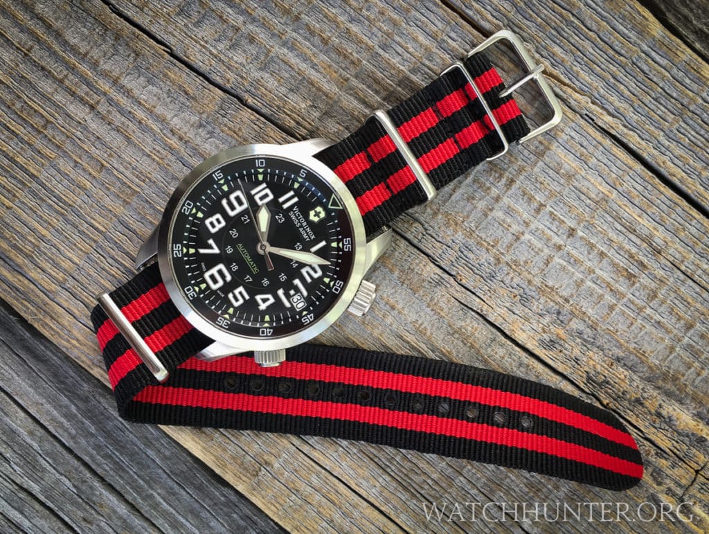 A Victorinox Swiss Army Airboss Mach 7 on a red & black striped 22 mm NATO